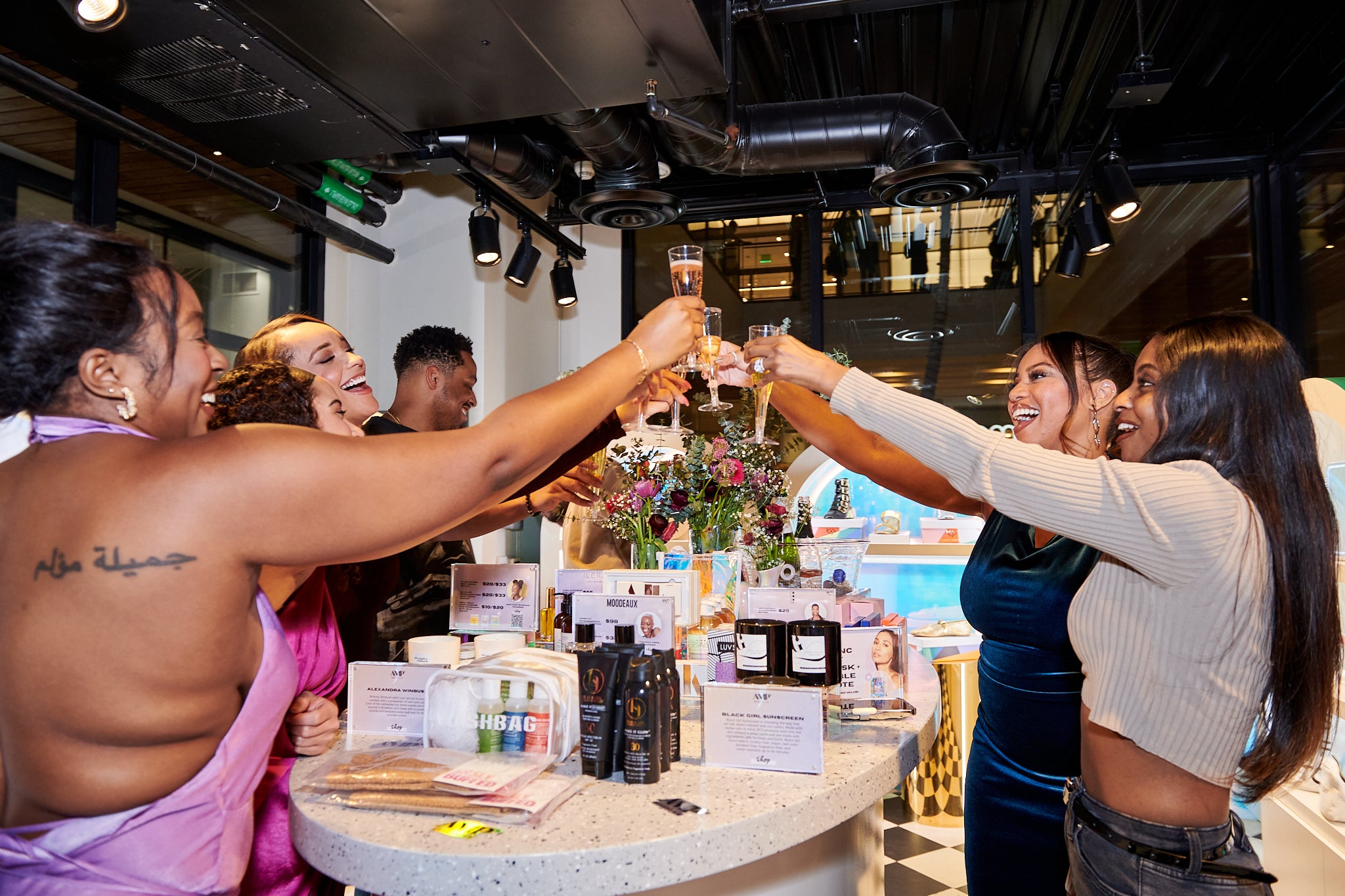 Diverse community gathered at an AMP Beauty in-store pop-up event